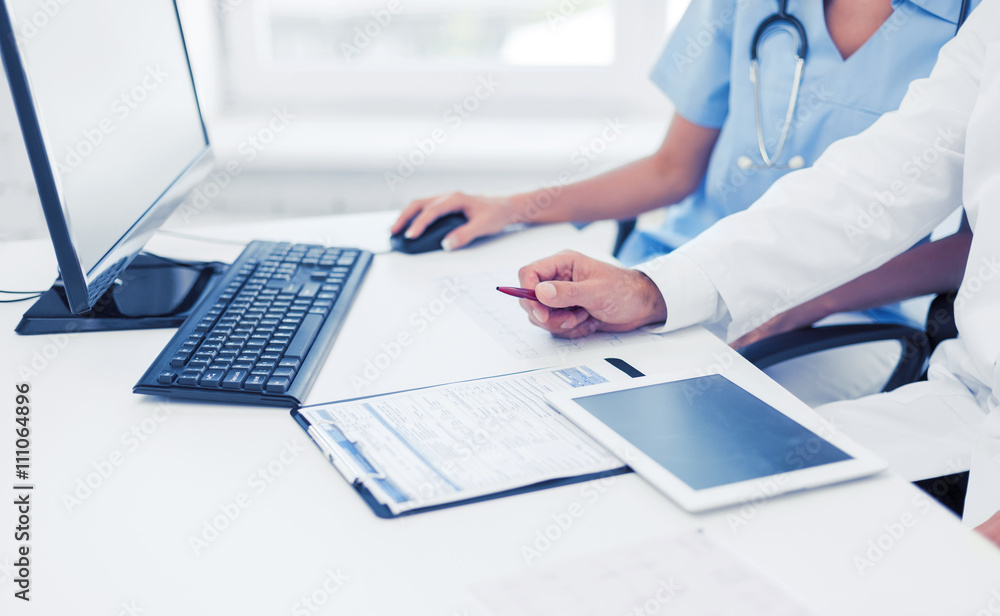 group of doctors looking at tablet pc group of doctors looking at tablet pc