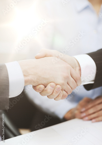 two businessmen shaking hands in office
