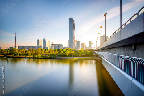 View on Donaucity with bridge in Vienna in the morning. Wide angle image with long exposure technic with glossy water and reflection © rh2010