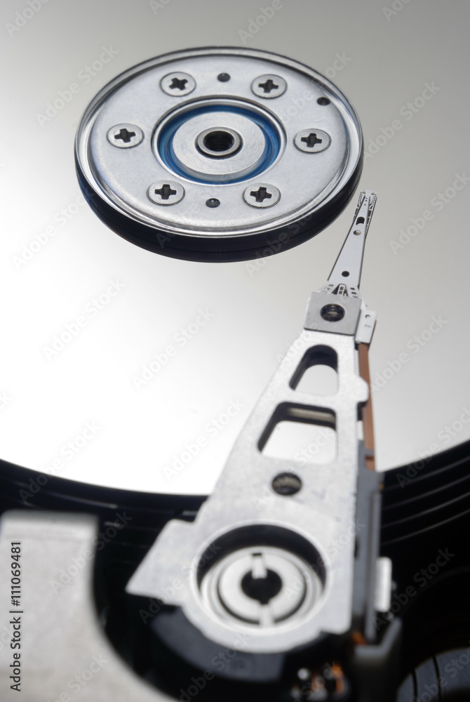 Close up of hard disk drive is a data storage device used for storing and retrieving digital information using rapidly rotating disks (platters) coated with magnetic material / hard disk drive Close up of hard disk drive is a data storage device used for storing and retrieving digital information using rapidly rotating disks (platters) coated with magnetic material / hard disk drive