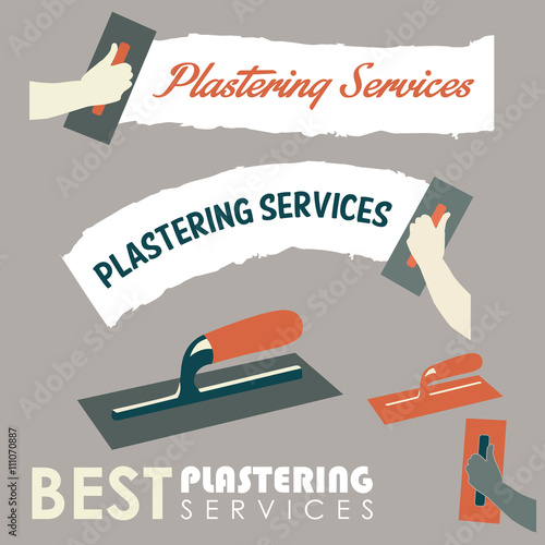 A hand holding a trowel plastering