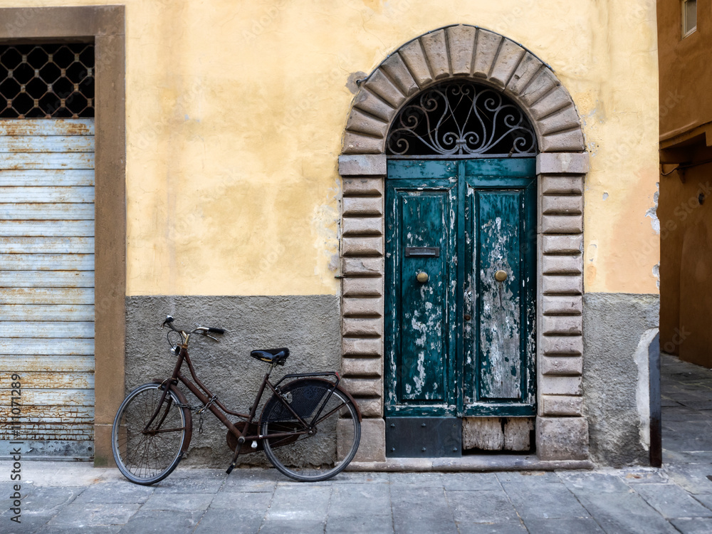 Fringed door and bike in Lucca