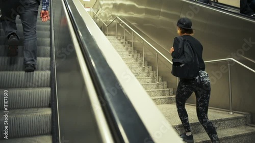 young sportive woman goes upstairs instead using escalator slow motion