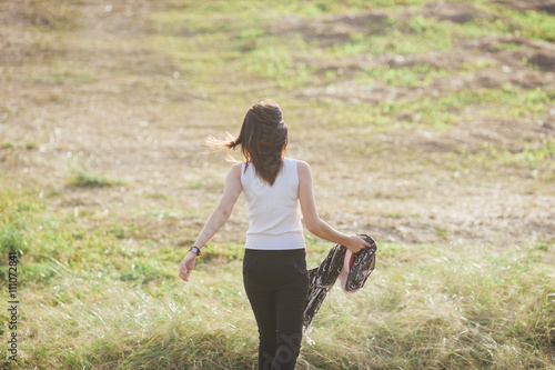 Walking girl on meadow.