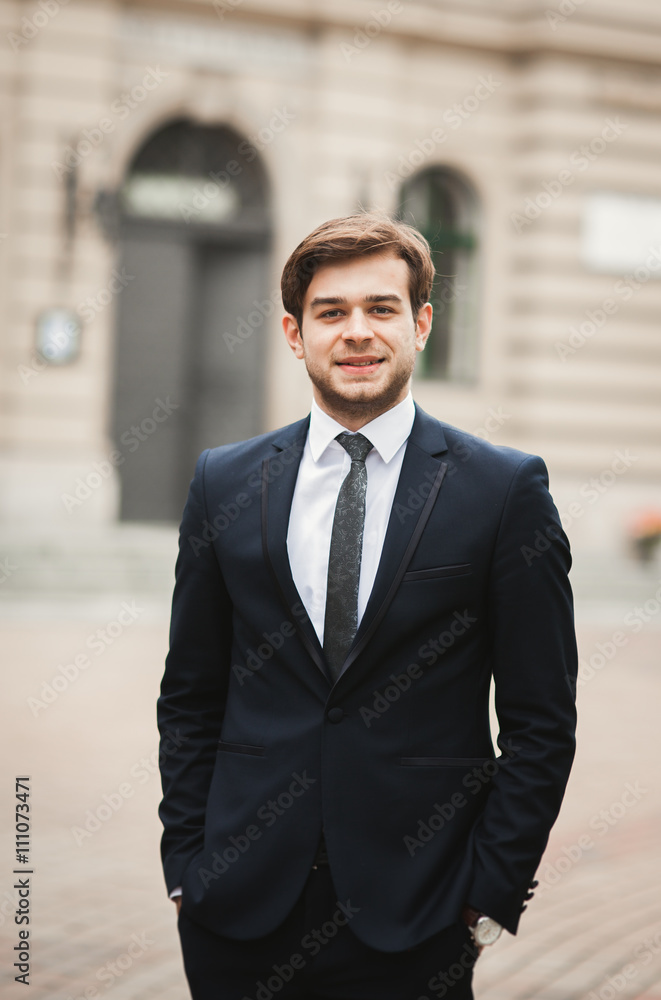 Fototapeta premium Handsome stylish young businessman posing portrait outdoor