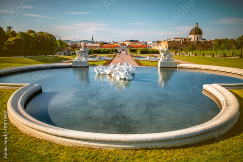 Beautiful fontain in Belvedere with lower palace and park on the background. Wide angle image with long exposure technic photo