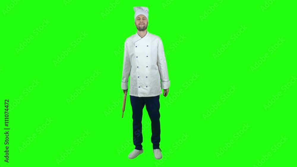 Professional baker standing on chroma key background and holding rolling pin Professional baker standing on chroma key background and holding rolling pin