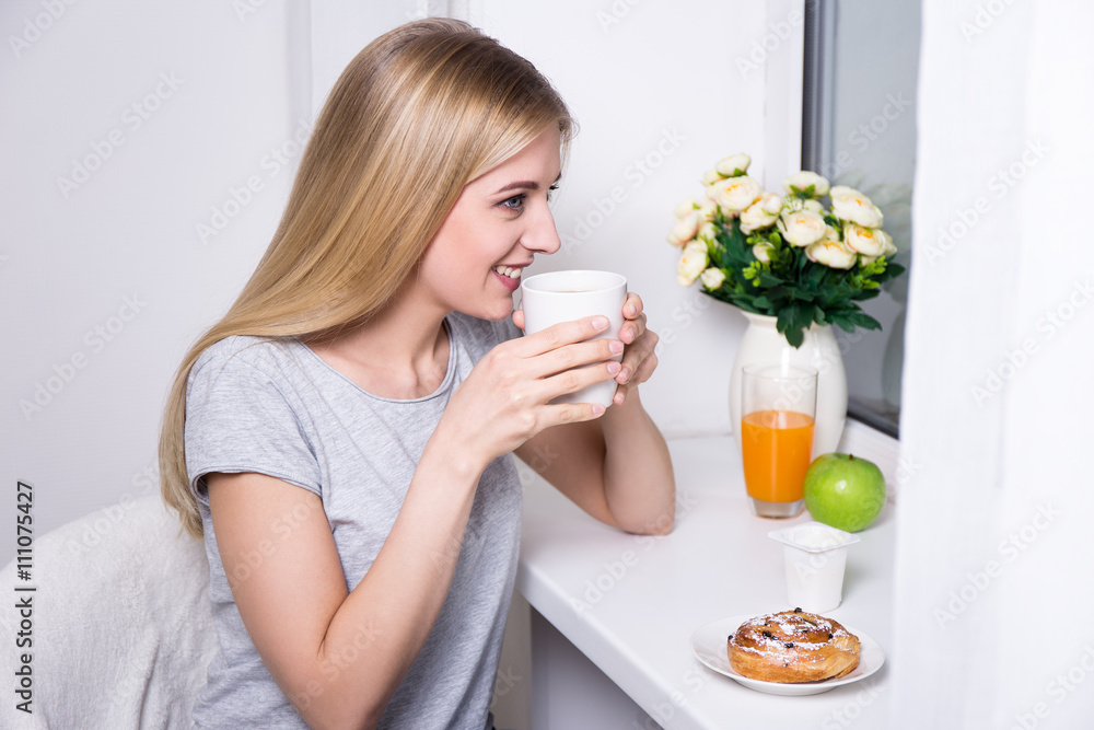 young smiling woman having breakfast at home young smiling woman having breakfast at home