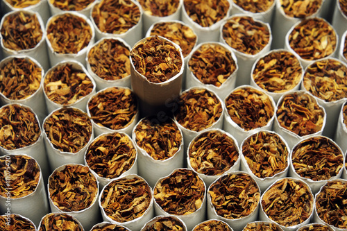 Heap of Tobacco Cigarettes, stack as a background texture, close up from the front
