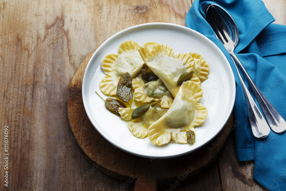 spinach ravioli with ricotta in a bowl on a wooden table. rustic
