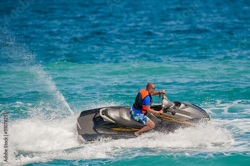 Young Man on Jet Ski, Tropical Ocean, Vacation Concept