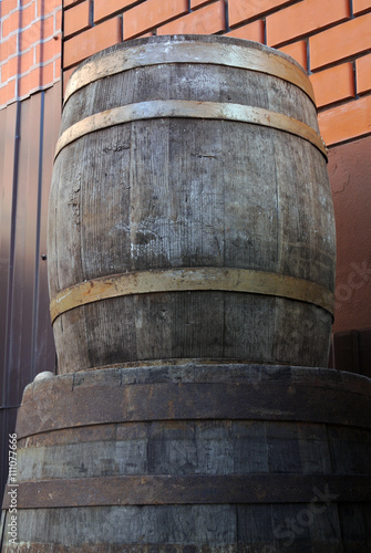 Old oak wine barrels on a background of red brick wall