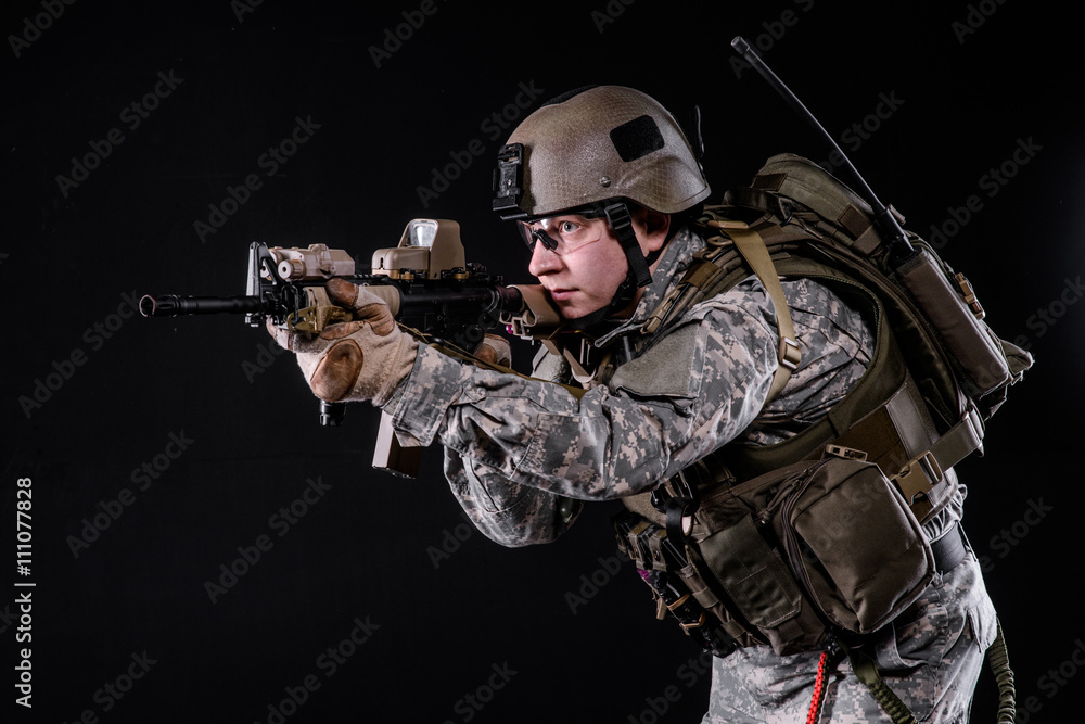 US Marine with gun/US Marine in uniform,helmet, body armor with rifle on black background