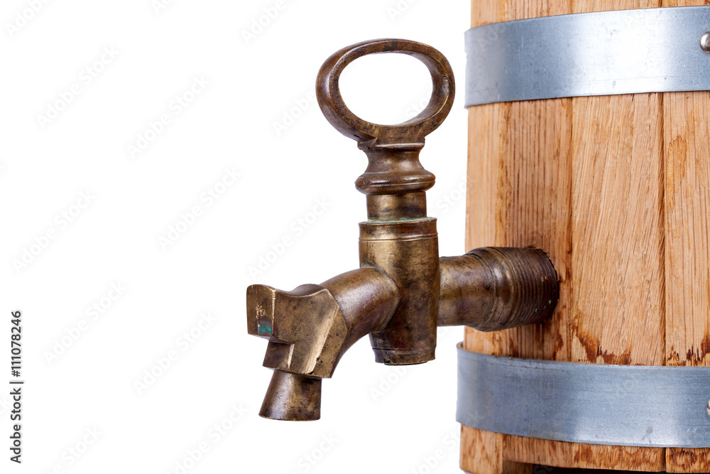 vintage brass faucet in an old oak barrel isolated