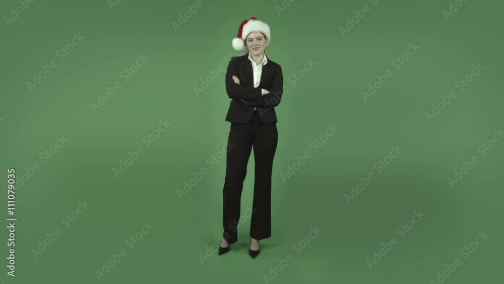 attractive caucasian business girl isolated on green with chirstmas hat attractive caucasian business girl isolated on green with chirstmas hat