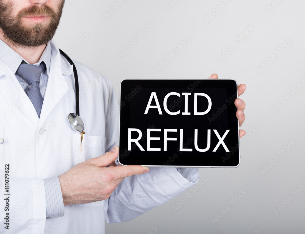 technology, internet and networking in medicine concept - Doctor holding a tablet pc with acid reflux sign. Internet technologies in medicine technology, internet and networking in medicine concept - Doctor holding a tablet pc with acid reflux sign. Internet technologies in medicine