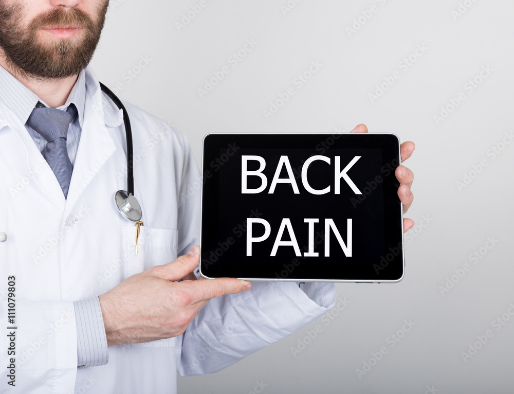 technology, internet and networking in medicine concept - Doctor holding a tablet pc with back pain sign. Internet technologies in medicine technology, internet and networking in medicine concept - Doctor holding a tablet pc with back pain sign. Internet technologies in medicine