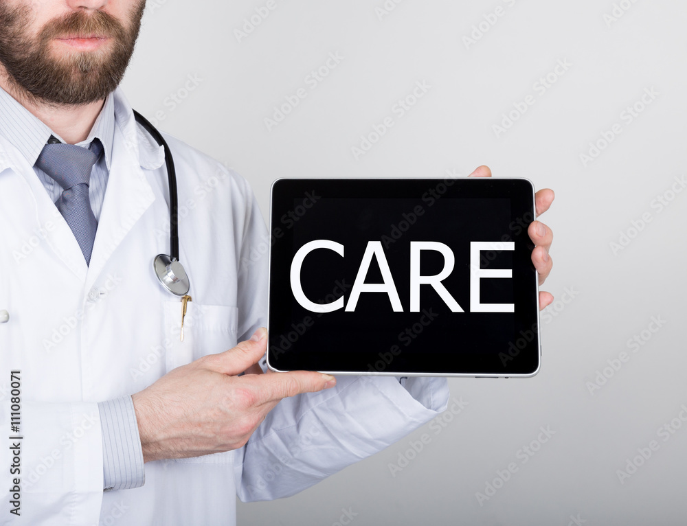 technology, internet and networking in medicine concept - Doctor holding a tablet pc with care sign. Internet technologies in medicine technology, internet and networking in medicine concept - Doctor holding a tablet pc with care sign. Internet technologies in medicine