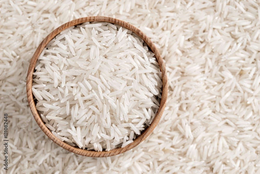 White rice in wooden bowl. Close up, top view, high resolution product. White rice in wooden bowl. Close up, top view, high resolution product.