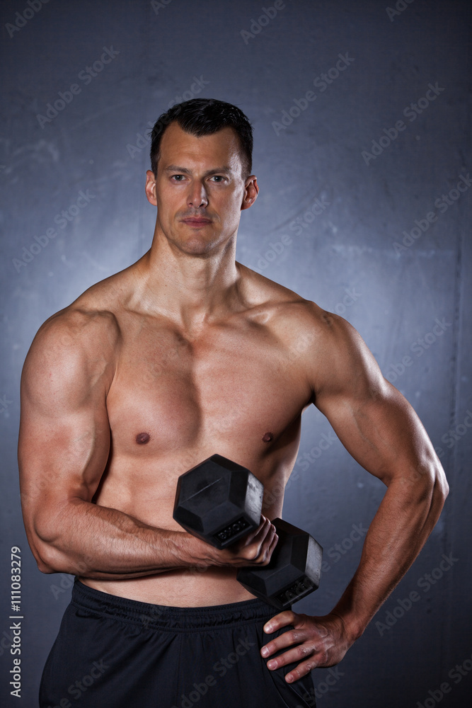 Man holding a dumbbell doing a fitness workout Man holding a dumbbell doing a fitness workout