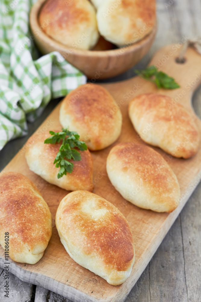 Fresh baked pasties on a chopping board. Fresh baked pasties on a chopping board.