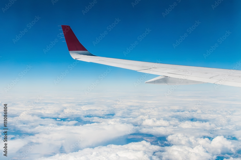 wings of airplane in the sky with cloud in sunny day wings of airplane in the sky with cloud in sunny day