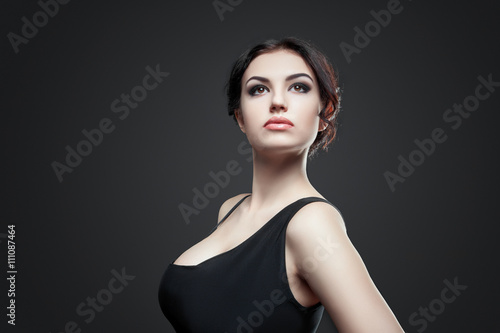 Portrait of beautiful female model on gray background
