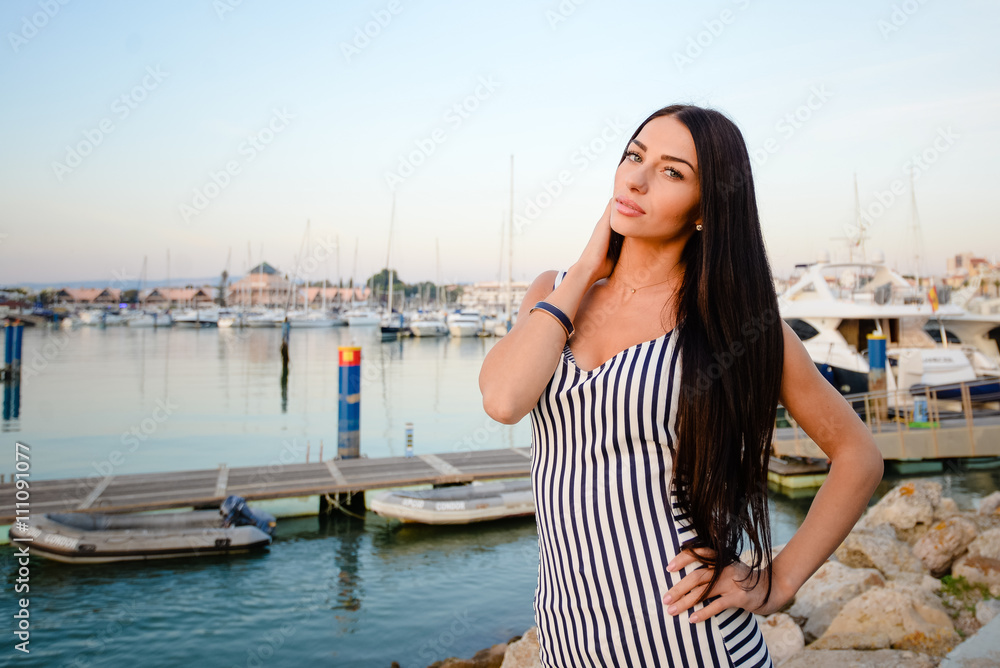 Beautiful attractive woman on yachts background