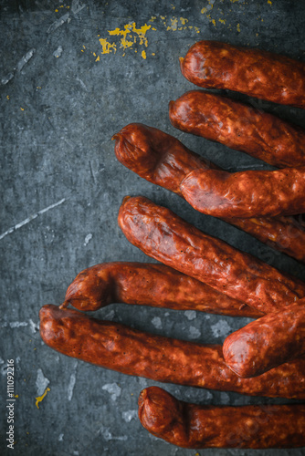 Smoked sausages on old metal background right