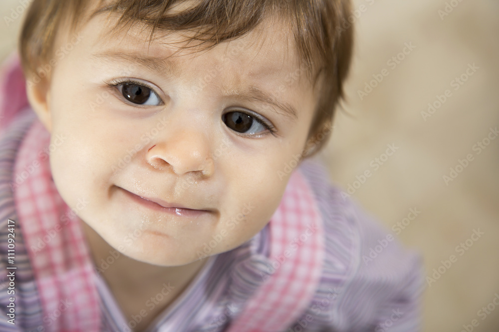 Close-up of adorable little baby looking away Close-up of adorable little baby looking away