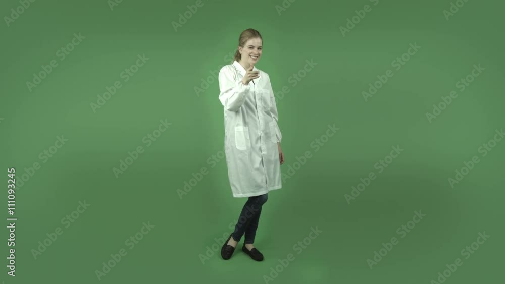 attractive caucasian girl with lab coat isolated on green with call me hand sign attractive caucasian girl with lab coat isolated on green with call me hand sign