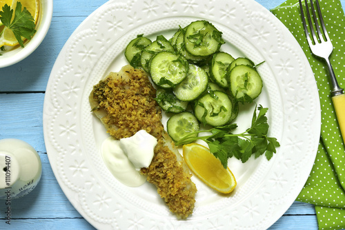 Cod baked with garlic bread crumbs garnished with cucumber salad