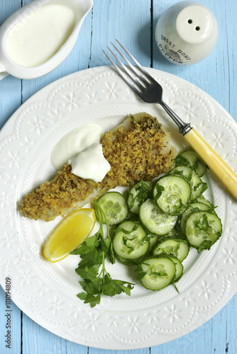 Cod baked with garlic bread crumbs garnished with cucumber salad