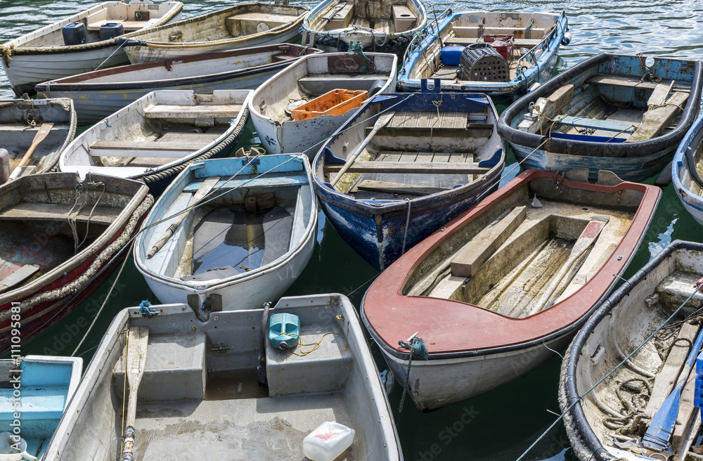 Colorful rowing boats tied up together in the harbor Colorful rowing boats tied up together in the harbor
