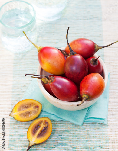 Tamarillo fruits with slice on blue napkin photo