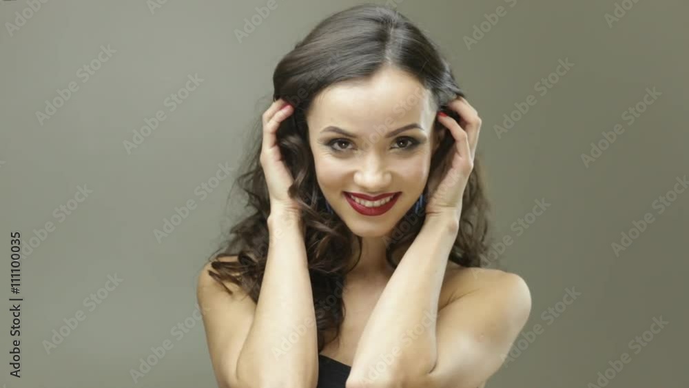 Brunette lady smiles and plays with her hair Brunette lady smiles and plays with her hair