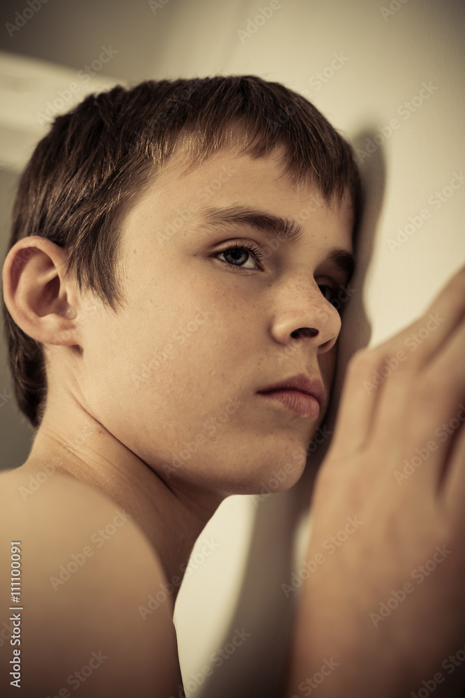 Young Teen Boy with Ear Pressed to Wall Young Teen Boy with Ear Pressed to Wall