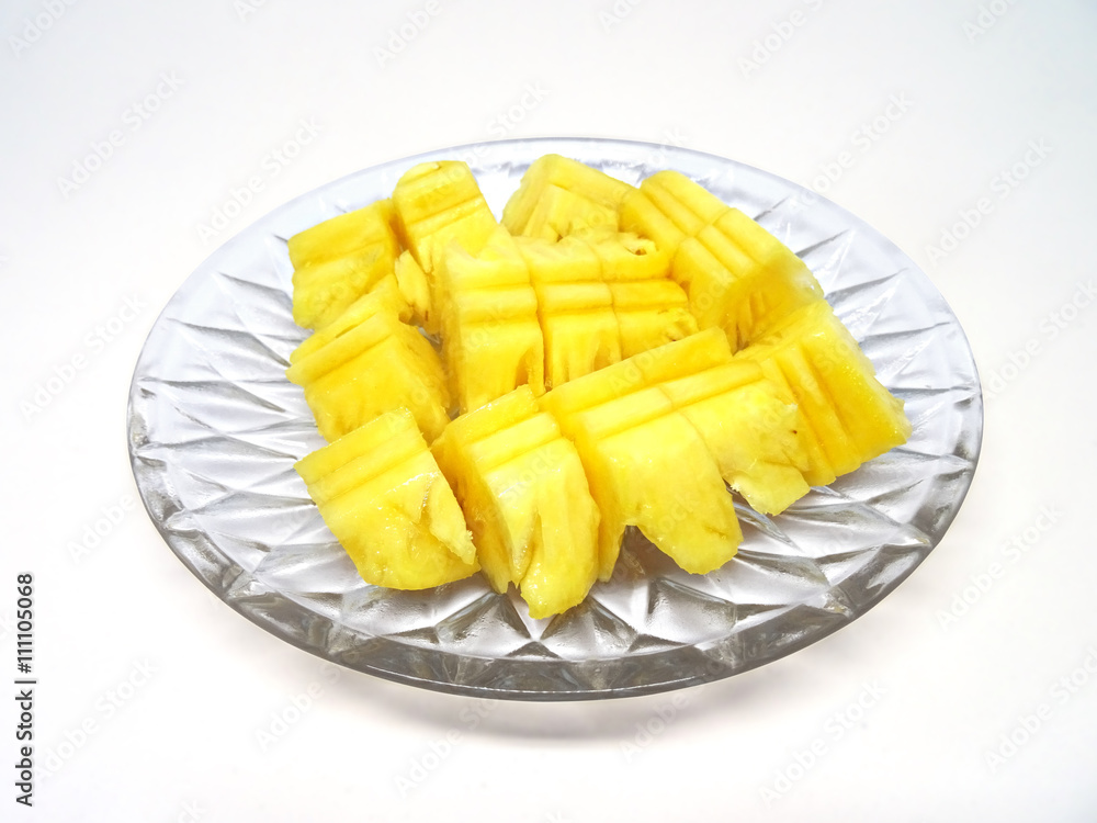 Diced pineapple fruit pieces on a glass plate
