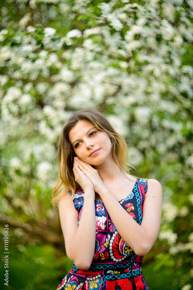 Beautiful woman in blooming garden