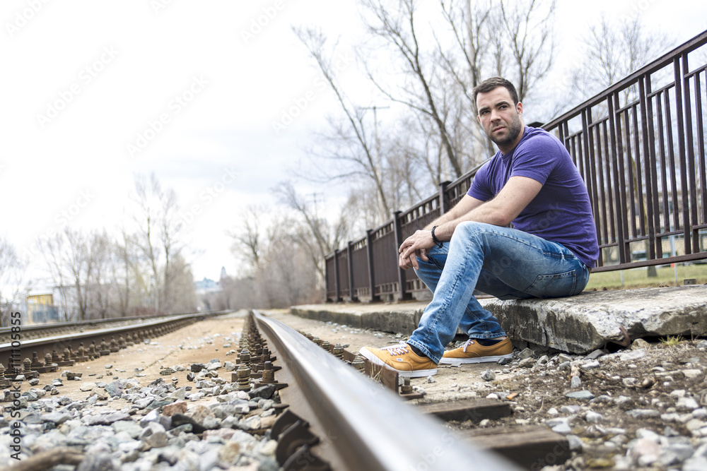 Fototapeta premium nice young man portrait on the railroad