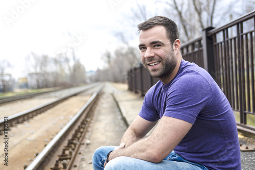 nice young man portrait on the railroad
