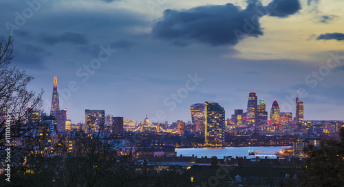 London, UK - Panoramic skyline view of central London with Tower Bridge, St.Paul's Cathedral, skyscrapers of Bank District and other famous landmarks taken from Greenwich park at dusk
