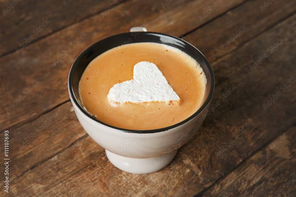 Cup of coffee with marshmallow on wooden table Cup of coffee with marshmallow on wooden table