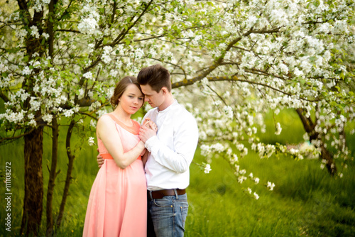 Couple in love under blooming branches spring day. © Aleksei Zakharov
