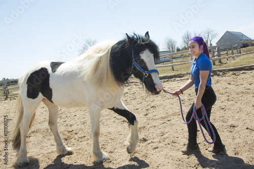 Beautiful teen girl on the farm with her horse. © Louis-Photo