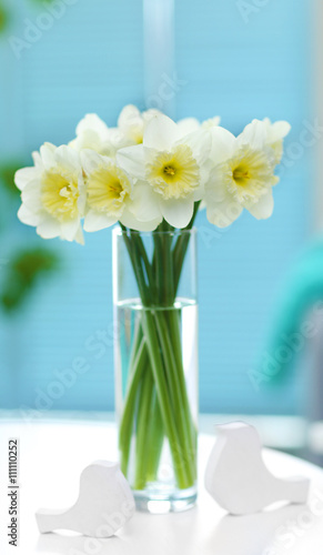 White narcissus in vase on the table indoors