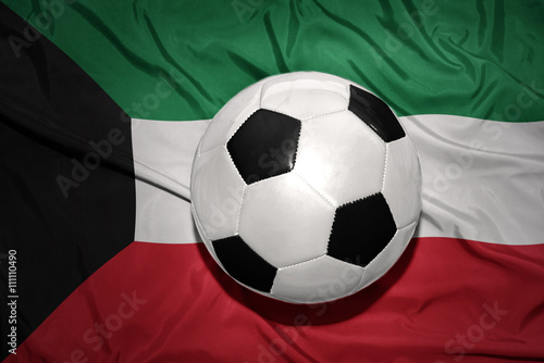 black and white football ball on the national flag of kuwait