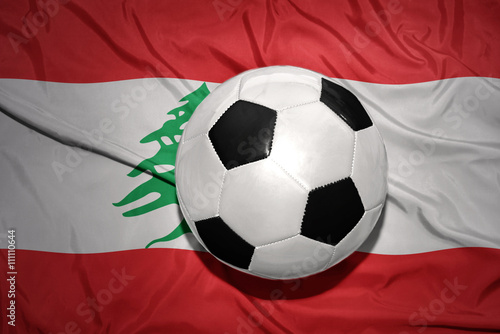 black and white football ball on the national flag of lebanon