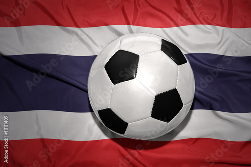 black and white football ball on the national flag of thailand