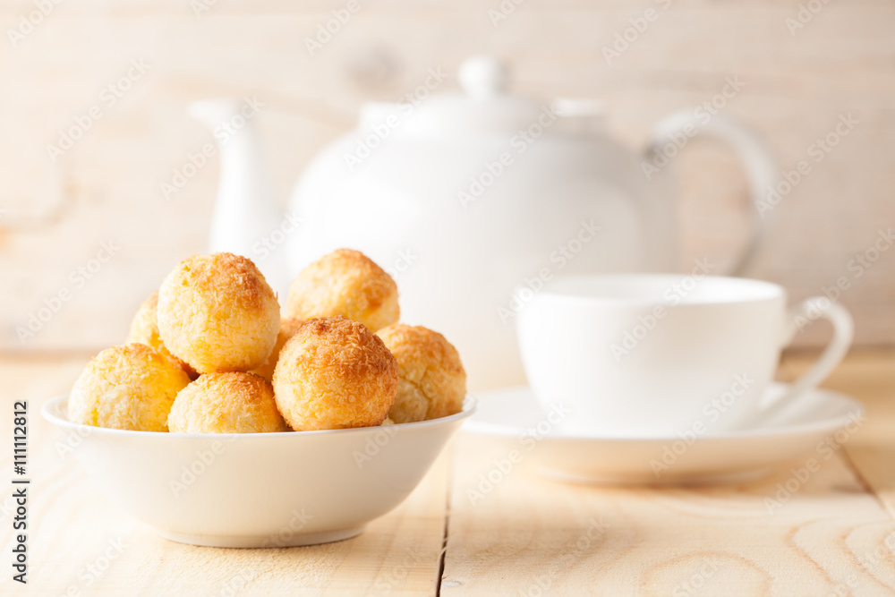 Fresh homemade coconut cookies in white bowl on wooden background. Sweet afternoon with tea. Fresh homemade coconut cookies in white bowl on wooden background. Sweet afternoon with tea.